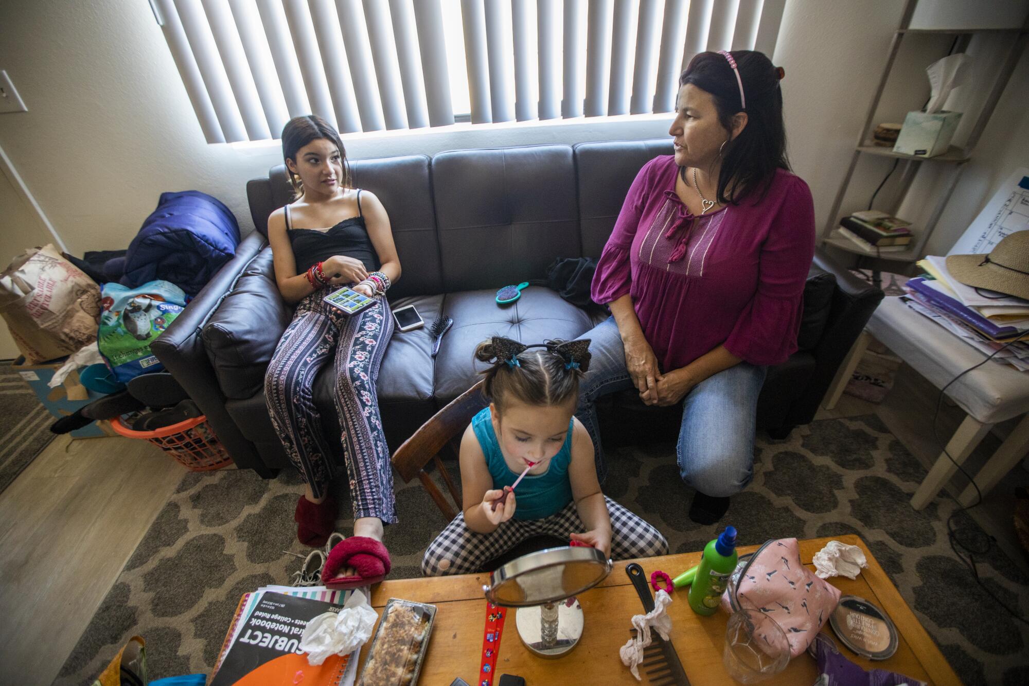 Three people in a living room