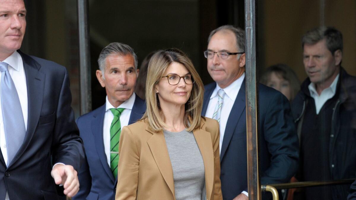 Actress Lori Loughlin exits the courthouse after facing charges in the college admissions scandal in Boston on April 3.