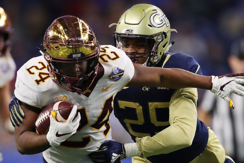 DETROIT, MICHIGAN - DECEMBER 26: Mohamed Ibrahim #24 of the Minnesota Golden Gophers battles for yards during a first half run while being tackled by Tariq Carpenter #29 of the Georgia Tech Yellow Jackets during the Quick Lane Bowl at Ford Field on December 26, 2018 in Detroit, Michigan. (Photo by Gregory Shamus/Getty Images) ** OUTS - ELSENT, FPG, CM - OUTS * NM, PH, VA if sourced by CT, LA or MoD **