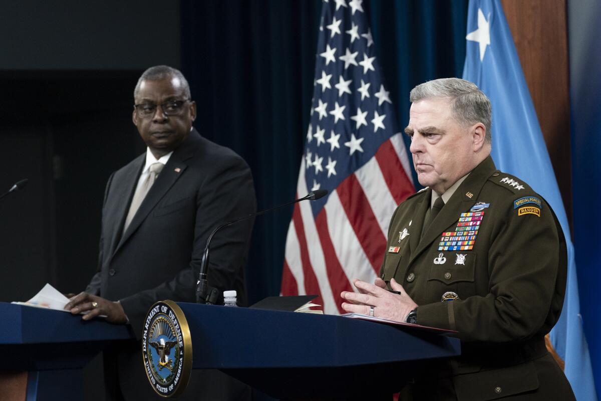 Two men stand side by side at lecterns.