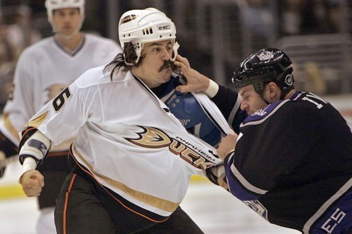 The Ducks' George Parros fights the Kings' Raitis Ivanans in a game.