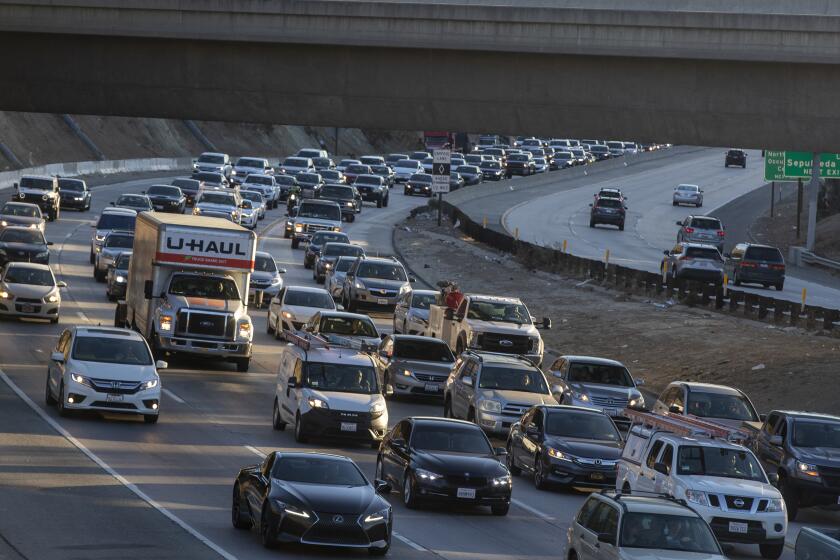 LOS ANGELES, CA - November 24 2021: Traffic backs up on northbound 405 at the merge with I5 as folks get in and out of town on Thanksgiving Eve on Wednesday, Nov. 24, 2021 in Los Angeles, CA. (Brian van der Brug / Los Angeles Times
