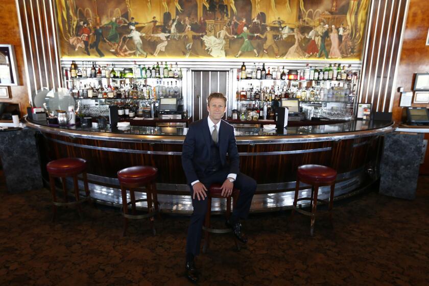Taylor Woods, a principal of Urban Commons, sits at the Observation Bar aboard Queen Mary. Woods' firm is proposing a $15 million makeover of the ship.