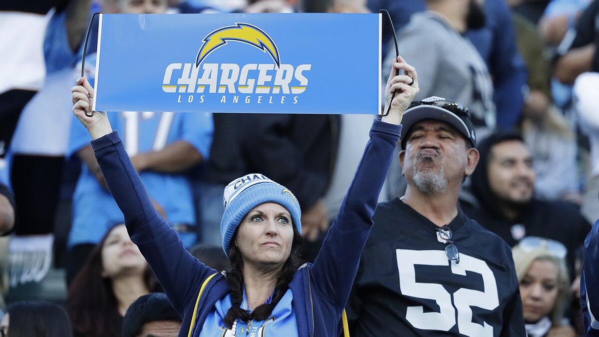 A fan has reason to cheer as the Chargers defeat the Oakland Raiders 30-10.