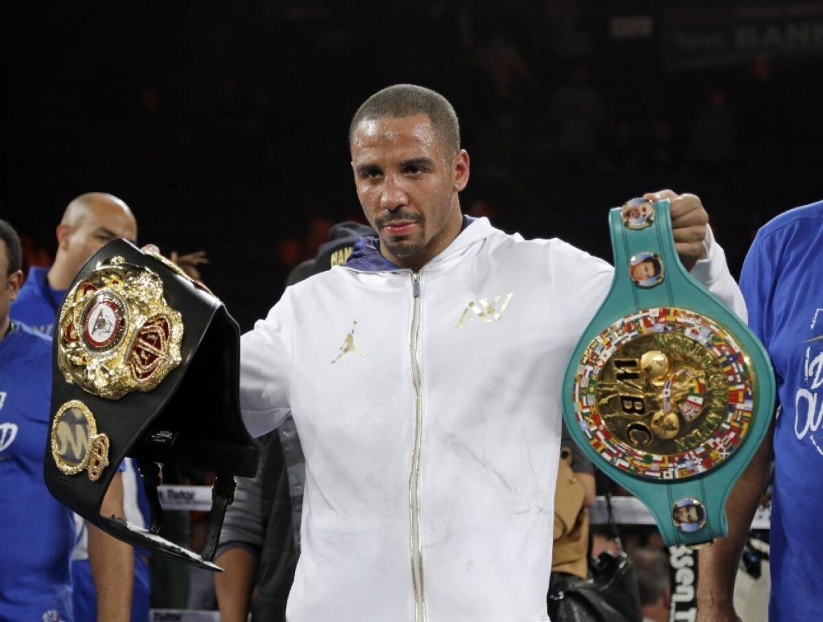 Andre Ward holds up championship belts after his defeat of Edwin Rodriguez in their super-middleweight championship boxing match.