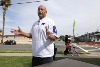 Randall Godinet, former executive director of the Oceanside Boys & Girls Club, speaks about the troubles in the city's Eastside neighborhood while standing along San Diego Street at the edge of Balderrama Park.