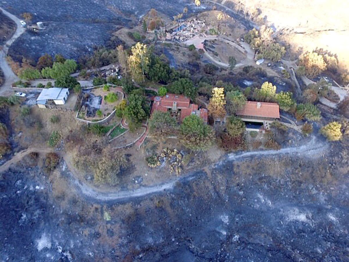 "Rancho Culbergo," the Lobo Canyon home of Leah and Paul Culberg, is a oasis of green after the Woolsey Fire razed surrounding chaparral and 12 neighboring homes on Nov. 9, 2018.