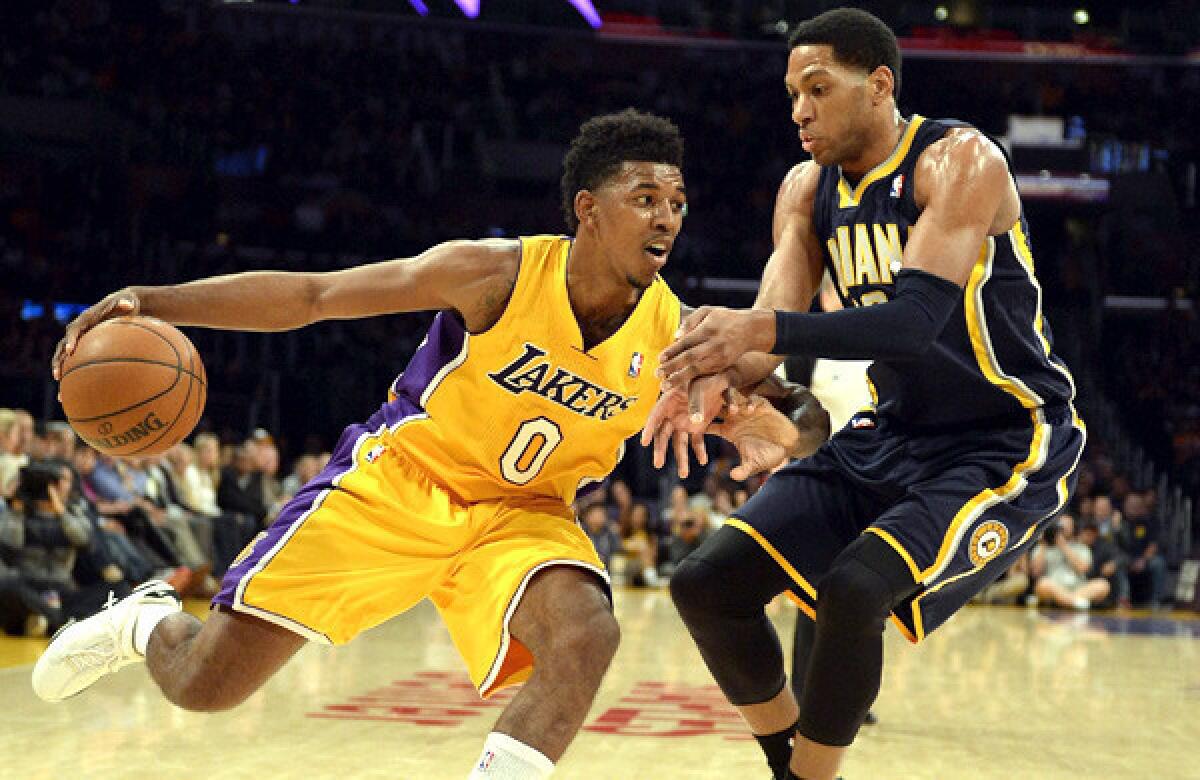 Lakers forward Nick Young drives against Pacers forward Danny Granger during a game last week at Staples Center.