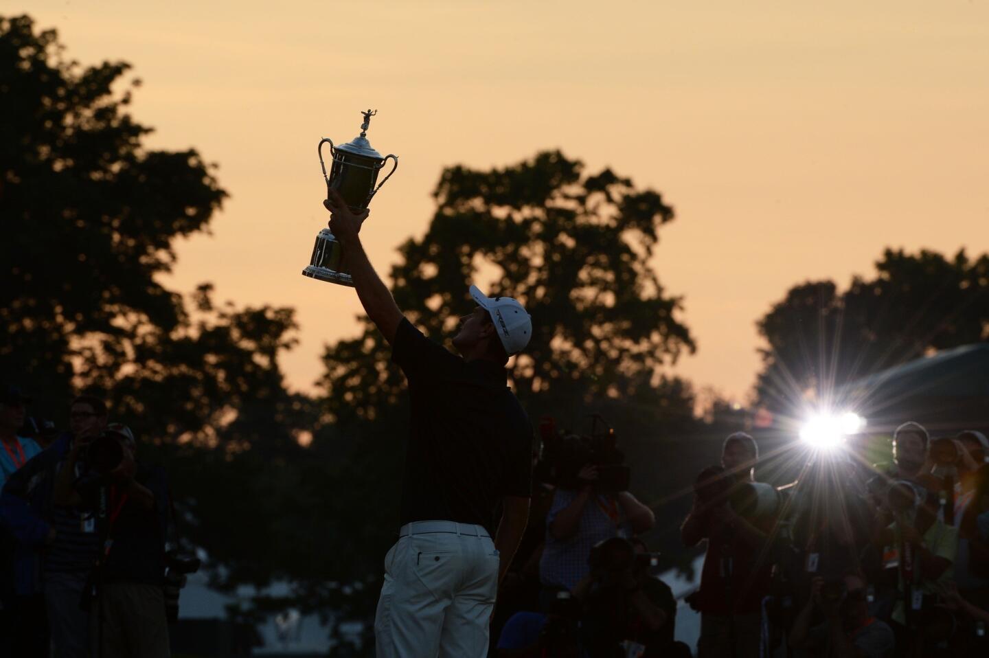 Justin Rose holds the winner's trophy aloft during the U.S. Open awards ceremony at Merion Golf Club on Sunday in Ardmore, Pa. It was the Englishman's first major victory.