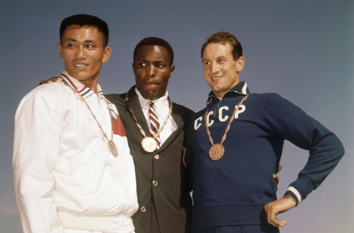 The decathlon medalists in the 1960 Rome Olympics stand next to each other.