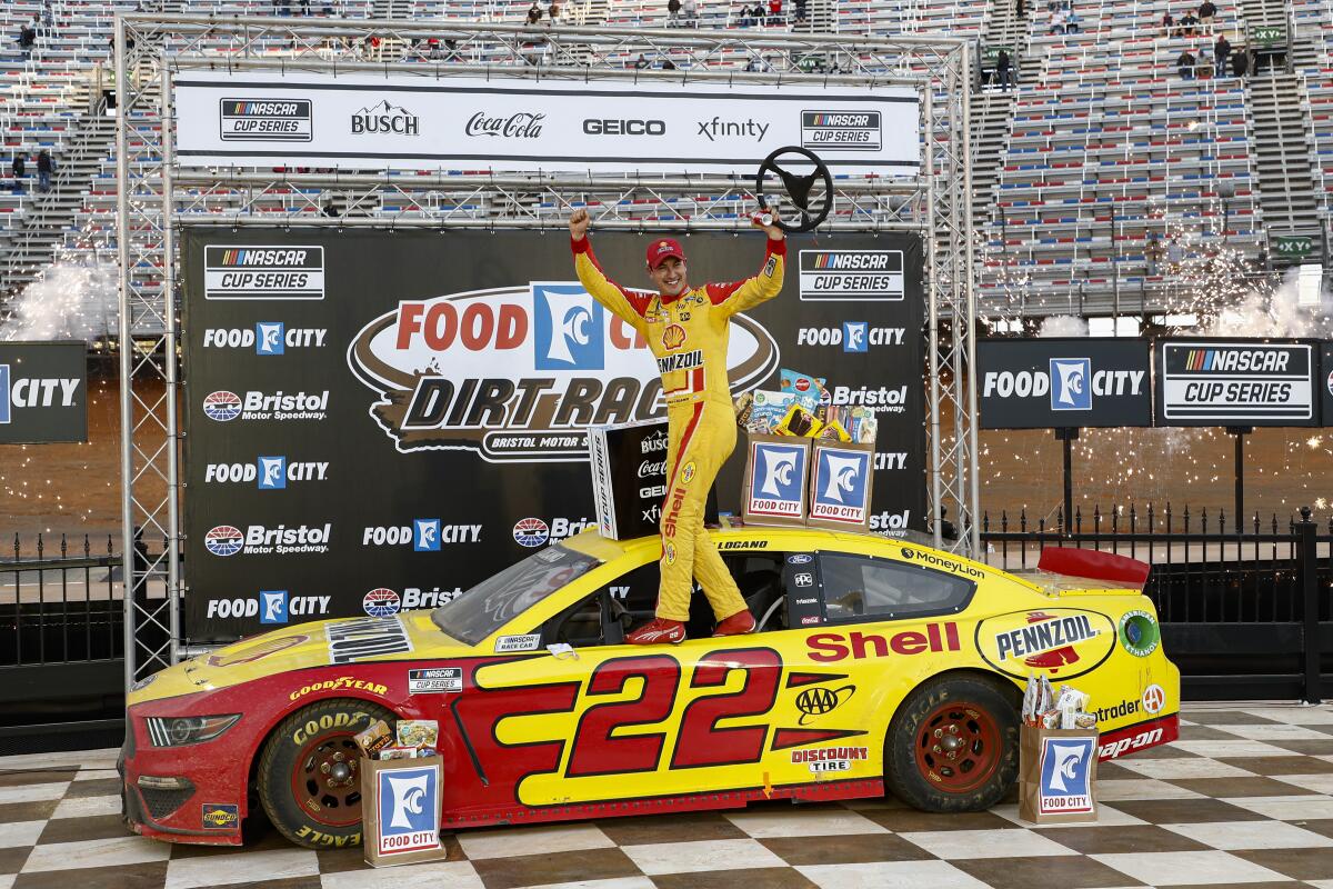 Joey Logano celebrates after winning a NASCAR Cup Series race.