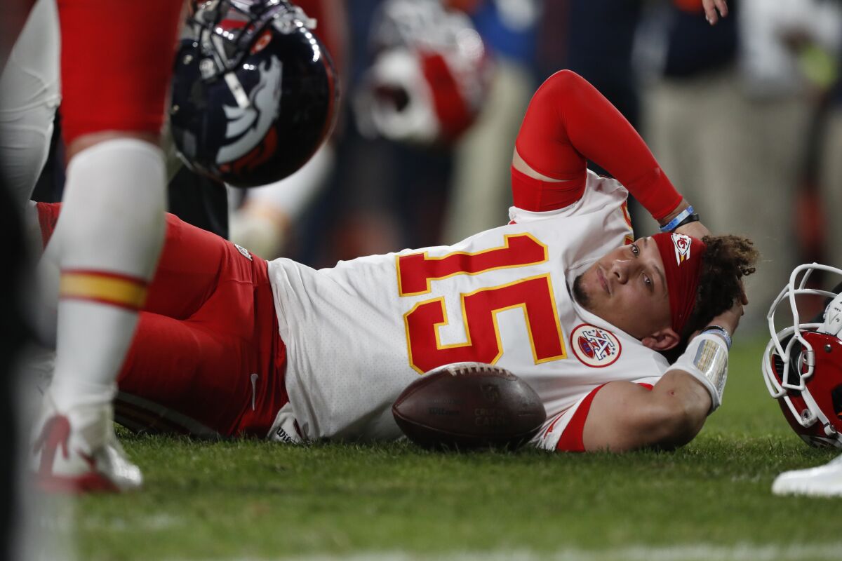 Kansas City Chiefs quarterback Patrick Mahomes lies on the field after being injured against the Denver Broncos on Thursday night.