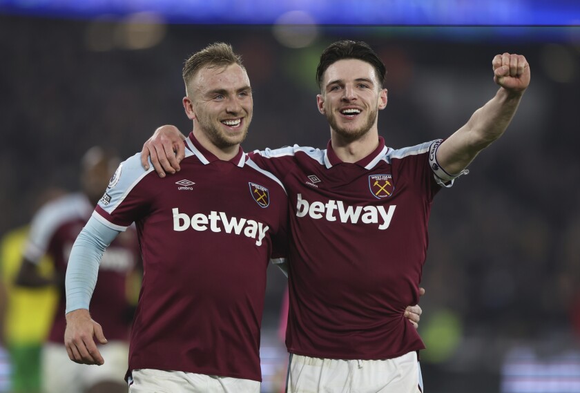 West Ham's Jarrod Bowen, left, celebrates after scoring his side's second goal during the English Premier League soccer match between West Ham United and Norwich City at the London Stadium in London, England, Wednesday, Jan. 12, 2022. (AP Photo/Ian Walton)