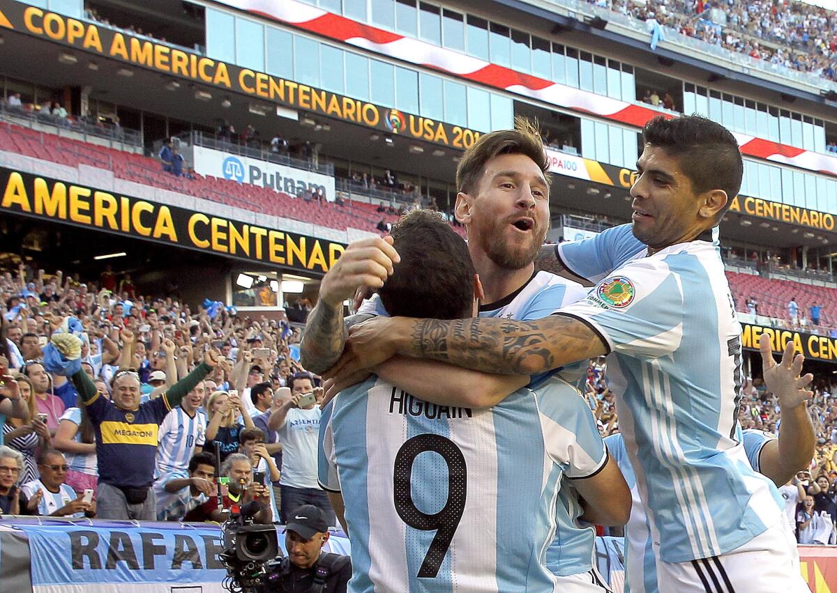 Argentina's Gonzalo Higuain (9) celebrates his goal with Lionel Messi, center, and Ever Banega in the first half of a Copa America Centenario match against Venezuela.