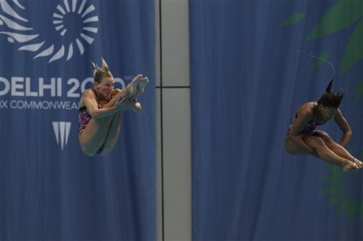 Canada's Jennifer Abel and Emile Heymans, left, compete in the women's 3 m springboard final to win the gold during the Commonwealth Games at the Dr. S.P. Mukherjee Aquatics Center in New Delhi, India, Sunday, Oct. 10, 2010. (AP Photo/Domenico Stinellis)