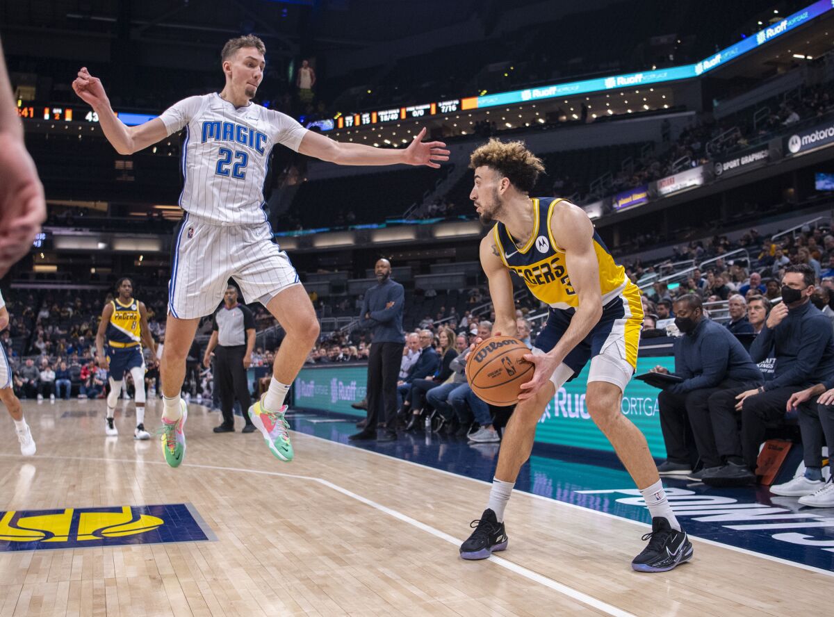 Indiana Pacers guard Chris Duarte (3) prepares to shoot as Orlando Magic forward Franz Wagner (22) defends during the first half of an NBA basketball game in Indianapolis, Wednesday, Feb. 2, 2022. (AP Photo/Doug McSchooler)