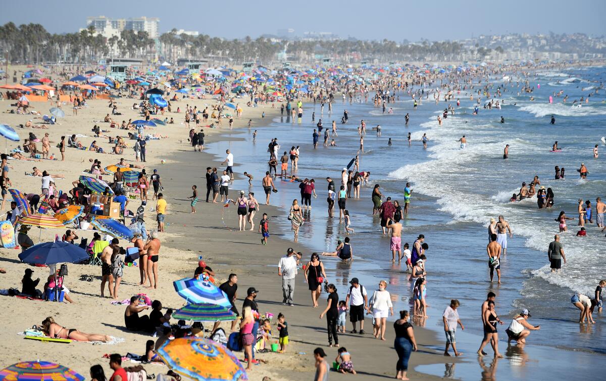 Beachgoers enjoy a sunny summer day in Santa Monica in August.