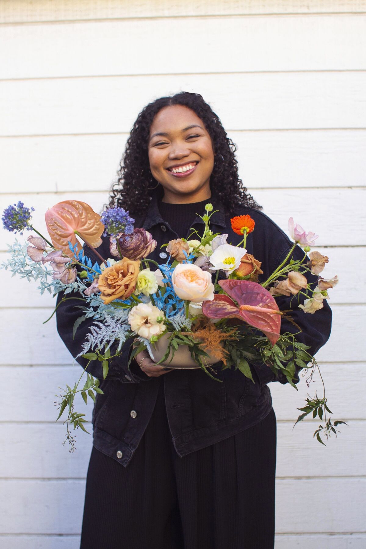 Mallory Browne holds a floral arrangement.
