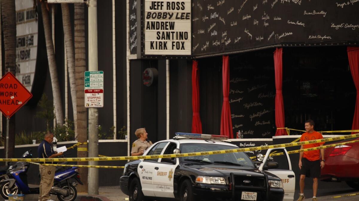 Los Angeles County Sheriff detectives investigate a shooting death in West Hollywood in 2015. (Al Seib / Los Angeles Times)