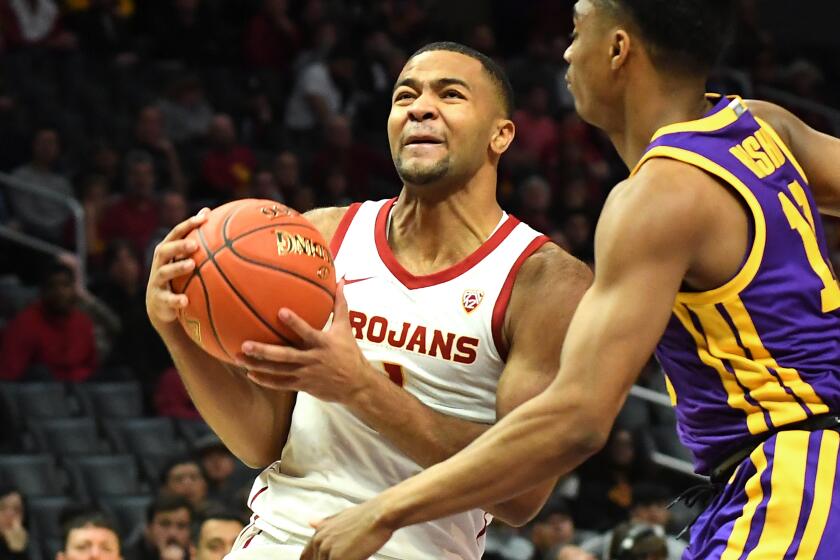 LOS ANGELES, CA - DECEMBER 21: James Bishop #10 of the LSU Tigers guards Kyle Sturdivant #1 of the USC Trojans as he drives to the basket in the first half of the game at Staples Center on December 21, 2019 in Los Angeles, California. (Photo by Jayne Kamin-Oncea/Getty Images)
