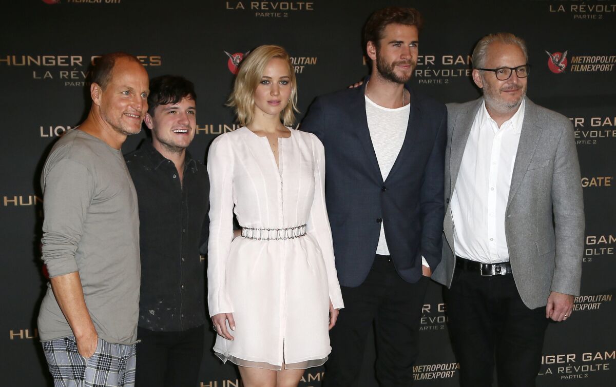 Actors Woody Harrelson, Josh Hutcherson, Jennifer Lawrence, Liam Hemsworth and director Francis Lawrence pose during a photocall for "The Hunger Games: Mockingjay - Part 2" at the Plaza Athenee hotel in Paris on Nov. 9, 2015.
