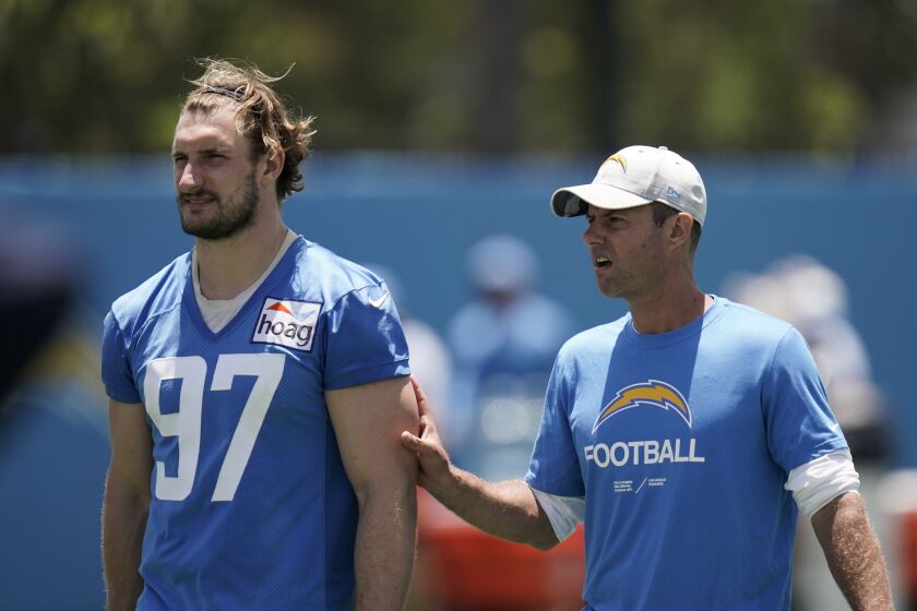 Los Angeles Chargers outside linebacker Joey Bosa, left, walks with head coach Brandon Staley during practice at the NFL football team's practice facility Wednesday, June 15, 2022, in Costa Mesa, Calif. (AP Photo/Jae C. Hong)