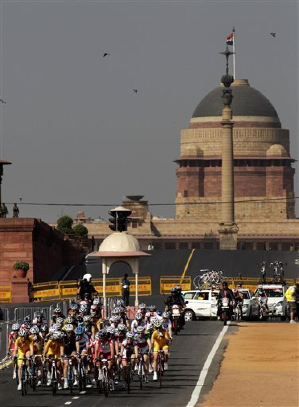 Participants ride past the Indian Presidential Palace in the women's 112km cycling road race during the Commonwealth Games in New Delhi, India, Sunday, Oct. 10, 2010. (AP Photo/Manish Swarup)