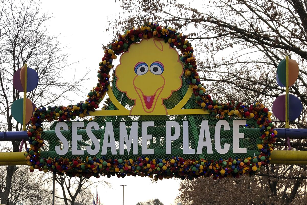 A decorated sign that says Sesame Place.
