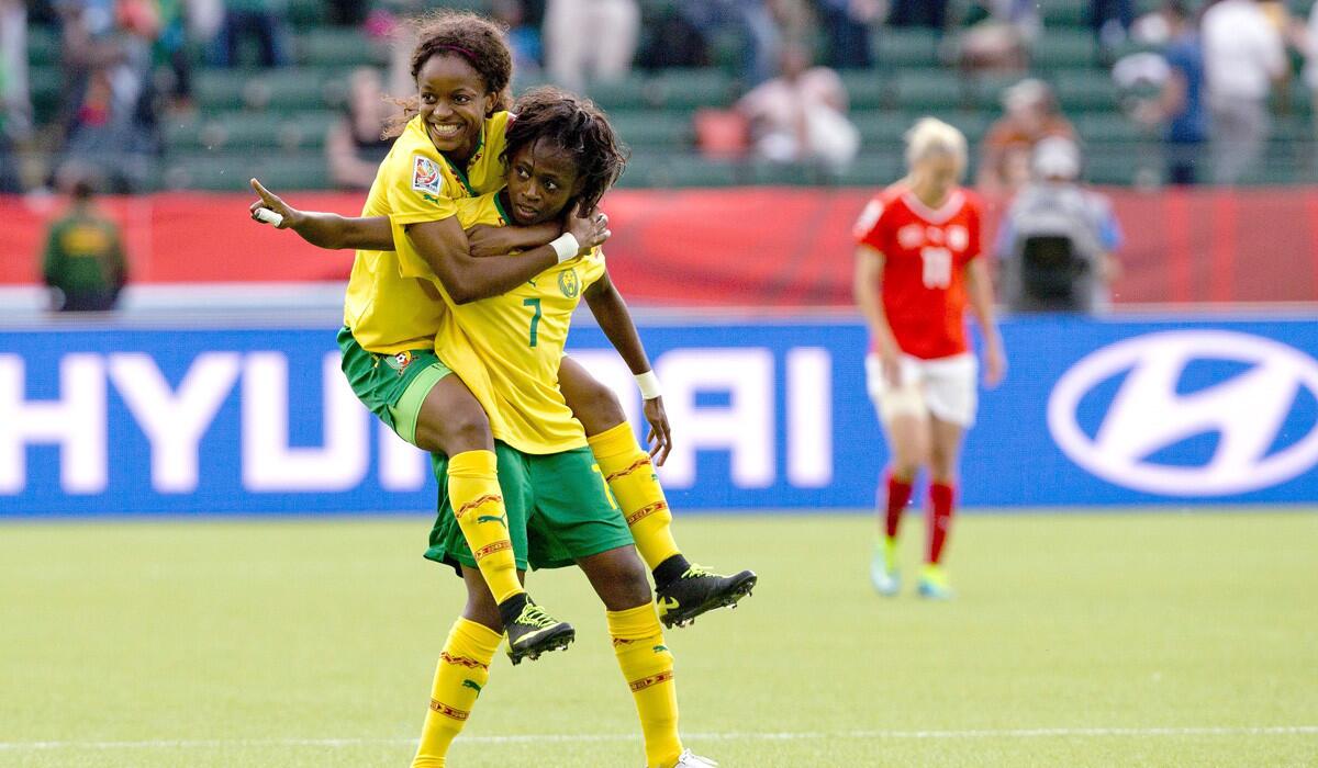 Cameroon's Gabrielle Onguene (7) and Jeannette Yango (10) celebrate a goal against Switzerland during the first half of a FIFA Women's World Cup soccer match on Tuesday.