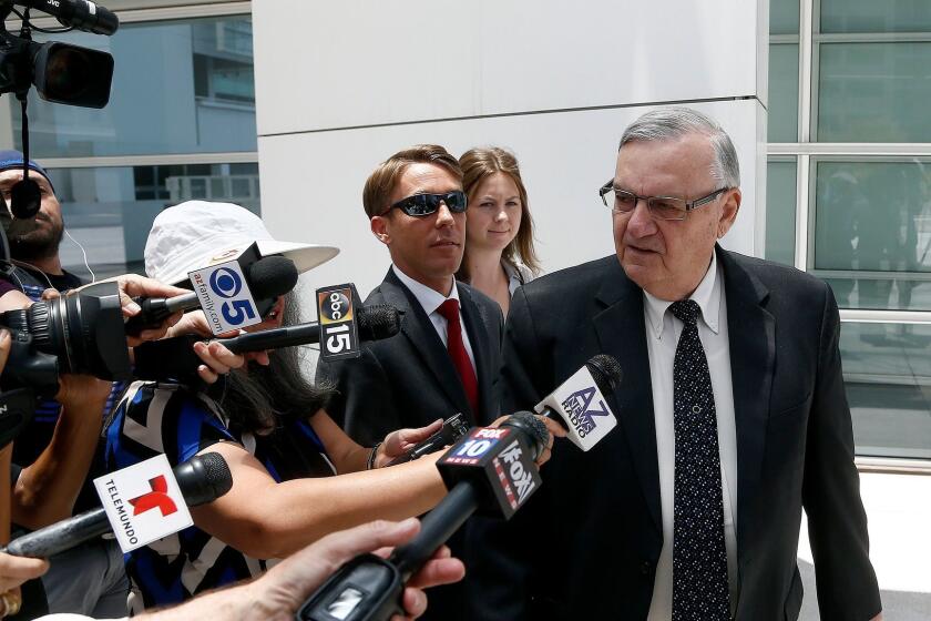 Former Maricopa County Sheriff Joe Arpaio, right, leaves U.S. District Court on the first day of his contempt-of-court trial Monday, June 26, 2017, in Phoenix. (AP Photo/Ross D. Franklin)