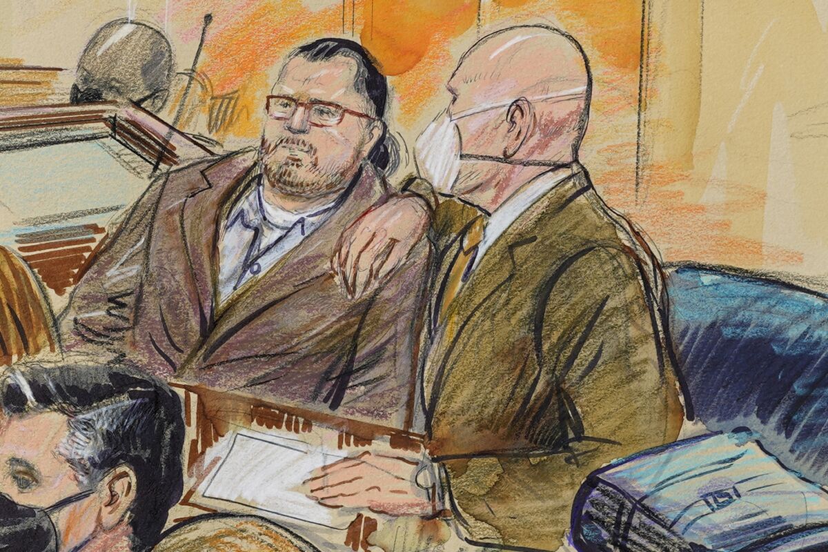 This artist sketch depicts Guy Wesley Reffitt, joined by his lawyer William Welch