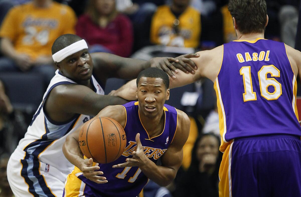 Lakers forward Wesley Johnson tries to get his hands on a rebound between Grizzlies power forward Zach Randolph and Lakers power forward Pau Gasol in the first half Wednesday night in Memphis.