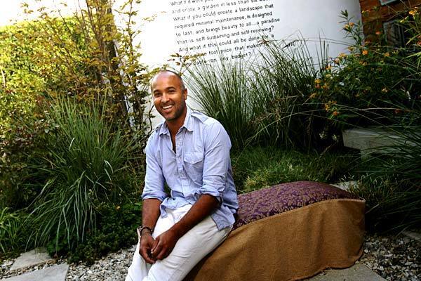 Call it the modern urban meadow. After two decades of gardening, landscape designer Sean Knibb has come up with a formula for lush but water-wise, small-scale city gardens. Lawns are replaced with gravel, concrete pavers and low, mounding grasses nestled among ornamental varieties such as paspalum, shown here, beneath the writing on the wall behind Knibb. Traditionally separated cutting beds, vegetable patches and herb gardens are abolished. Succulents, shrubs, such as the yellow milkweed (far right), flowers and edibles all mingle in the same beds. "Part of the aesthetic is to capture the look of where prairie meets forest," Knibb says. "The layering that happens in nature is the coolest thing." We recently toured three of Knibb's Los Angeles installations, each created from a palette of tough but showy plants and basic hardscape materials. Here, in the garden of his office and outdoor furniture showroom, Knibb sits on a slip-covered bale of hay that serves as a bench. (Keep clicking to see what he's done and close-up looks at some of the flowers.)
