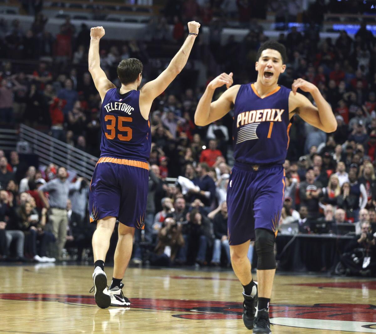 Suns forward Mirza Teletovic (35) celebrates after making the winning basket against the Bulls with less than one second left on the clock.