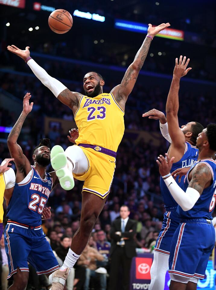 LeBron James loses the ball as he's fouled by Knicks guard Wayne Ellington, second from right, during the first quarter of a game Jan. 7 at Staples Center.