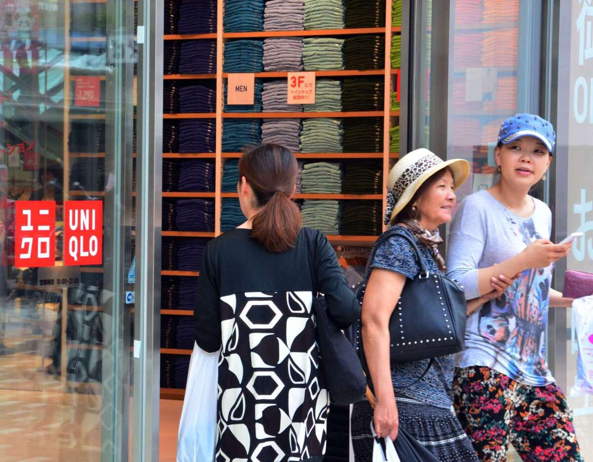 Customers shop at Japan's casual apparel giant Uniqlo in Tokyo. A Uniqlo pop-up shop has opened at South Coast plaza.