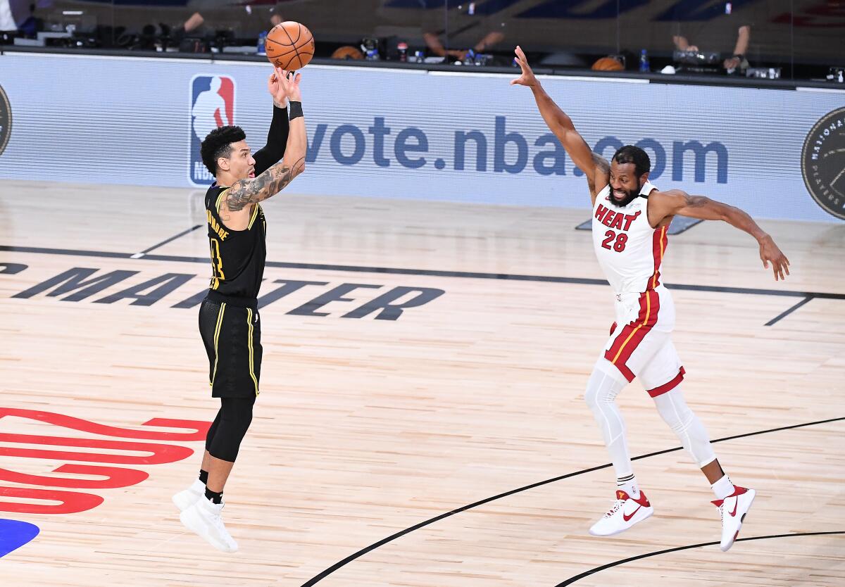 Lakers guard Danny Green misses a late three-point shot in front of Miami Heat defender Andre Iguodala.