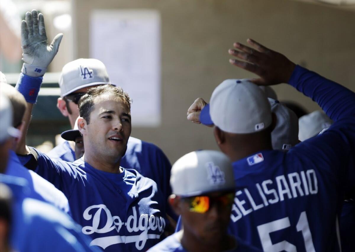 Dodgers' Andre Ethier celebrates in the dugout after his two-run home run against the Oakland Athletics on Sunday.