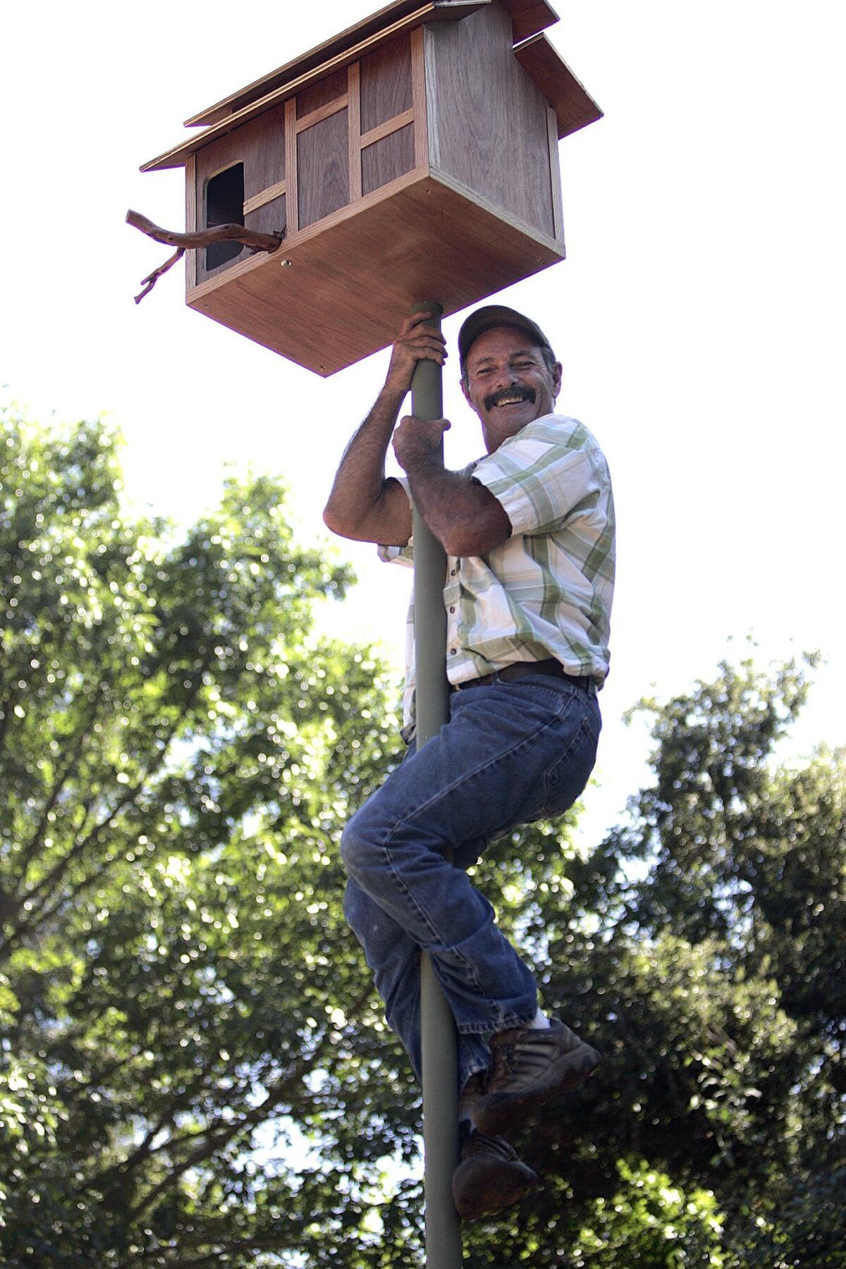 Tom Stephan gets a birds’-eye-view of an owl box he installed in Ramona. The top-of-the-line boxes can include a closed-circuit camera. — John Gastaldo