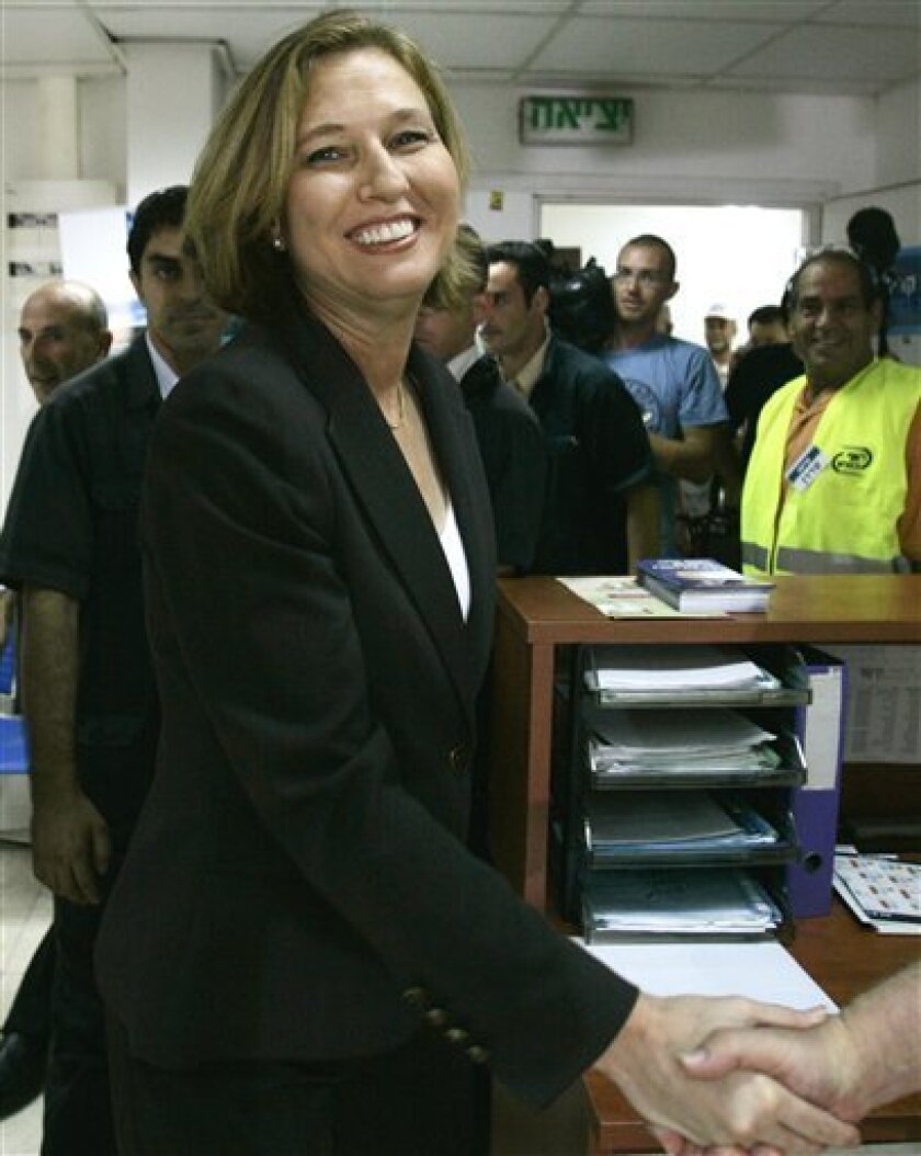 Israeli Foreign Minister and candidate for Kadima party leadership Tzipi Livni,left, is greeted by a supporter after casting her ballot in the Kadima primary in Tel Aviv, Israel, Wednesday, Sept. 17, 2008. TV exit polls say Livni has won a clear victory in the party primary election to replace Prime Minister Ehud Olmert. (AP Photo/Ariel Schalit)