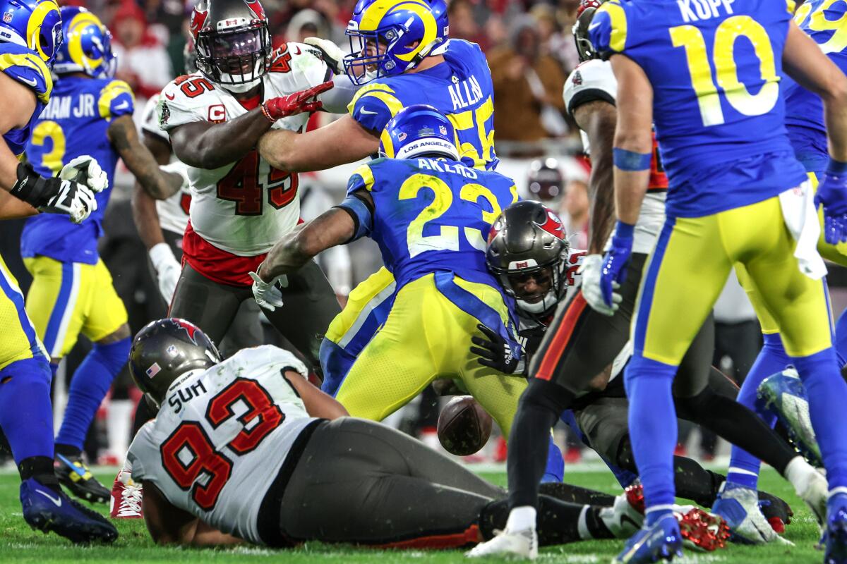 Rams running back Cam Akers (23) fumbles the ball late in the game against the Buccaneers.