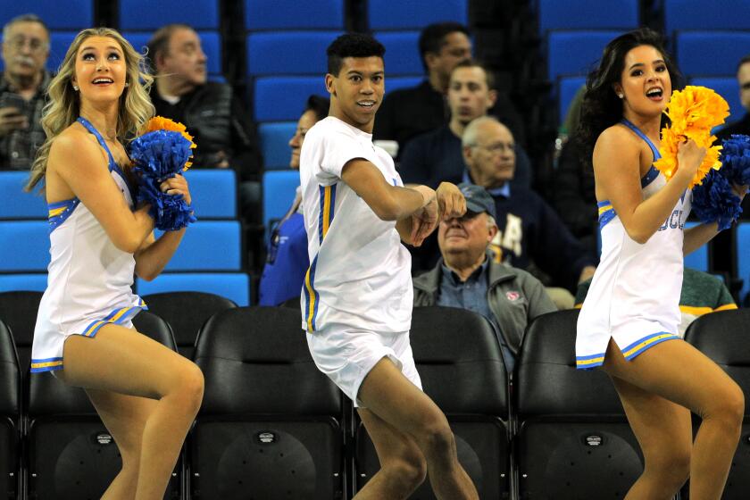 WESTWOOD, CA - DECEMBER 28, 2019: Devin Mallory, middle, performs with the UCLA dance team before the Bruins game against Cal State Fullerton on December 28, 2019 in Westwood, California. Mallory is the only male member on the dance team.(Gina Ferazzi/Los AngelesTimes)
