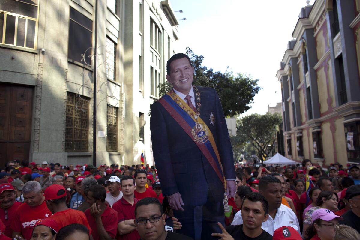 Supporters carry a life-size image of Venezuelan President Hugo Chavez during a symbolic inauguration ceremony Thursday in Caracas for the ailing leader. Chavez hasn't been seen or heard from in the month since he underwent cancer surgery in Cuba.