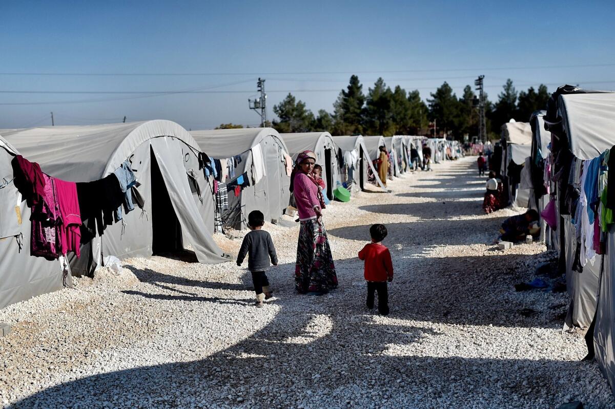 A Syrian mother and her children are among those living at a refugee camp in the Turkish town of Suruc on Nov. 12, 2014.