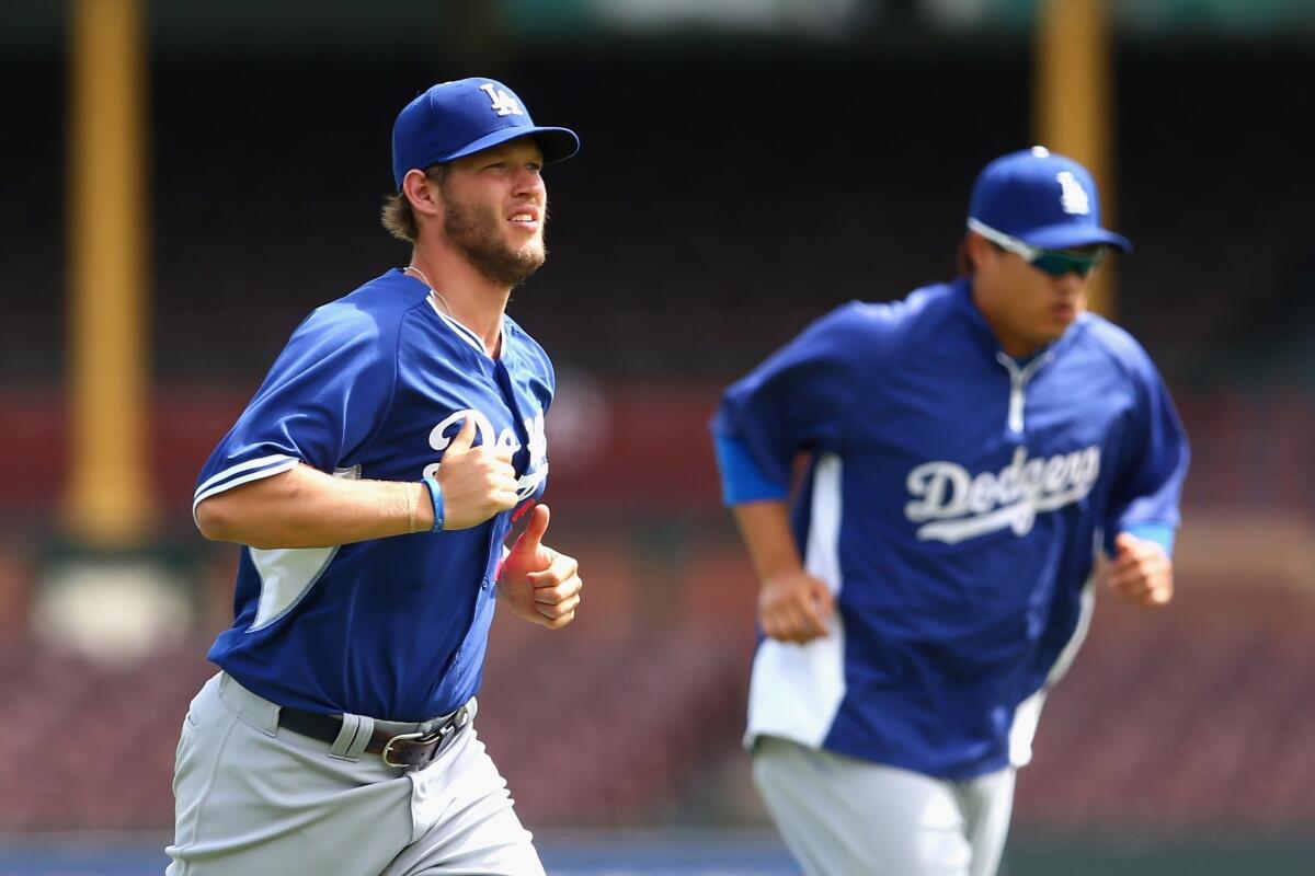 Dodgers ace Clayton Kershaw warms Friday up during a training session at Sydney Cricket Ground. Kershaw is slated to pitch in the Dodgers' season-opener against the Arizona Diamondbacks.