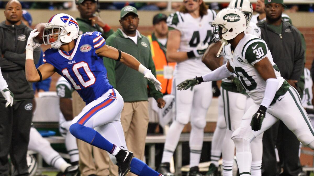 Buffalo Bills wide receiver Robert Woods, left, makes a catch while pursued by New York Jets cornerback Darrin Walls during the second quarter of the Bills' 38-3 victory in Detroit on Monday night.