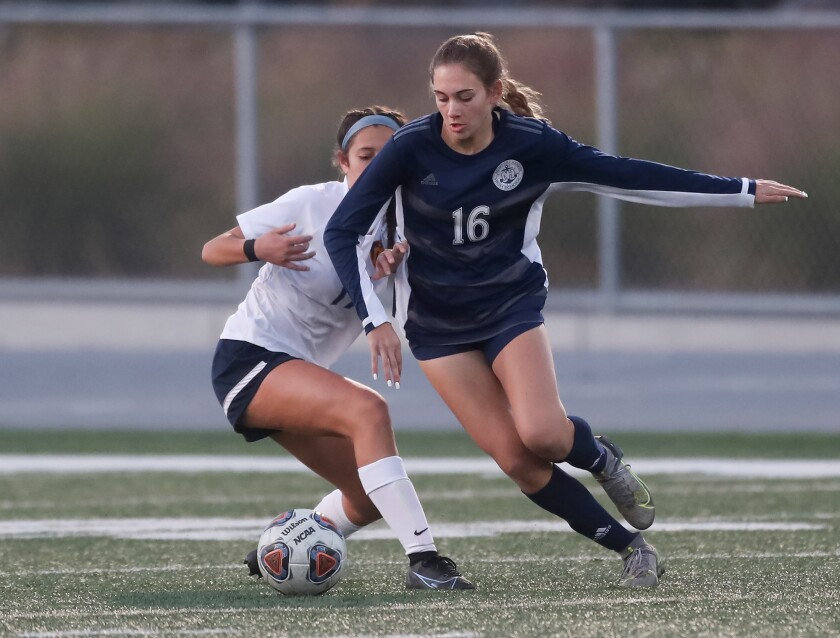 Newport Harbor's Sadie Hoch (16) looks for a shot as she dribbles the ball close to the box against Marina on Tuesday.