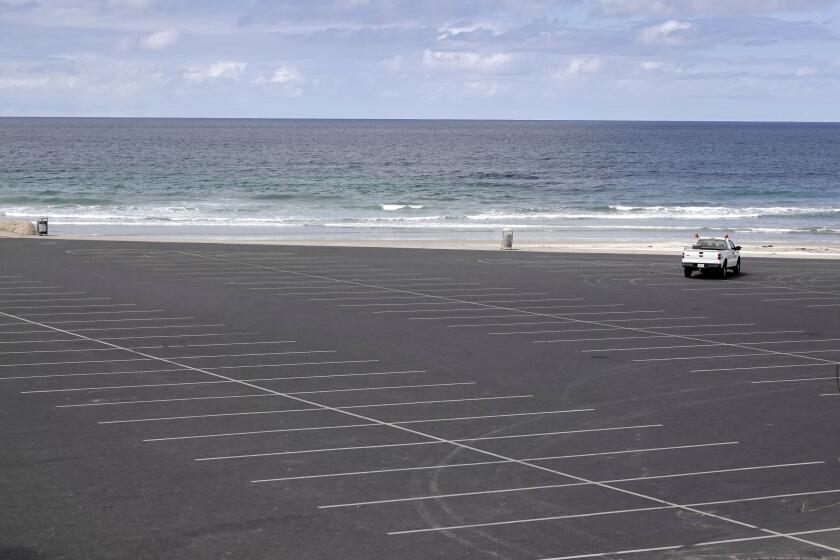 The Seaside Reef parking lot in Cardiff State beach sits empty April 5, 2020. All beaches in San Diego County have been closed due to COVID-19.
