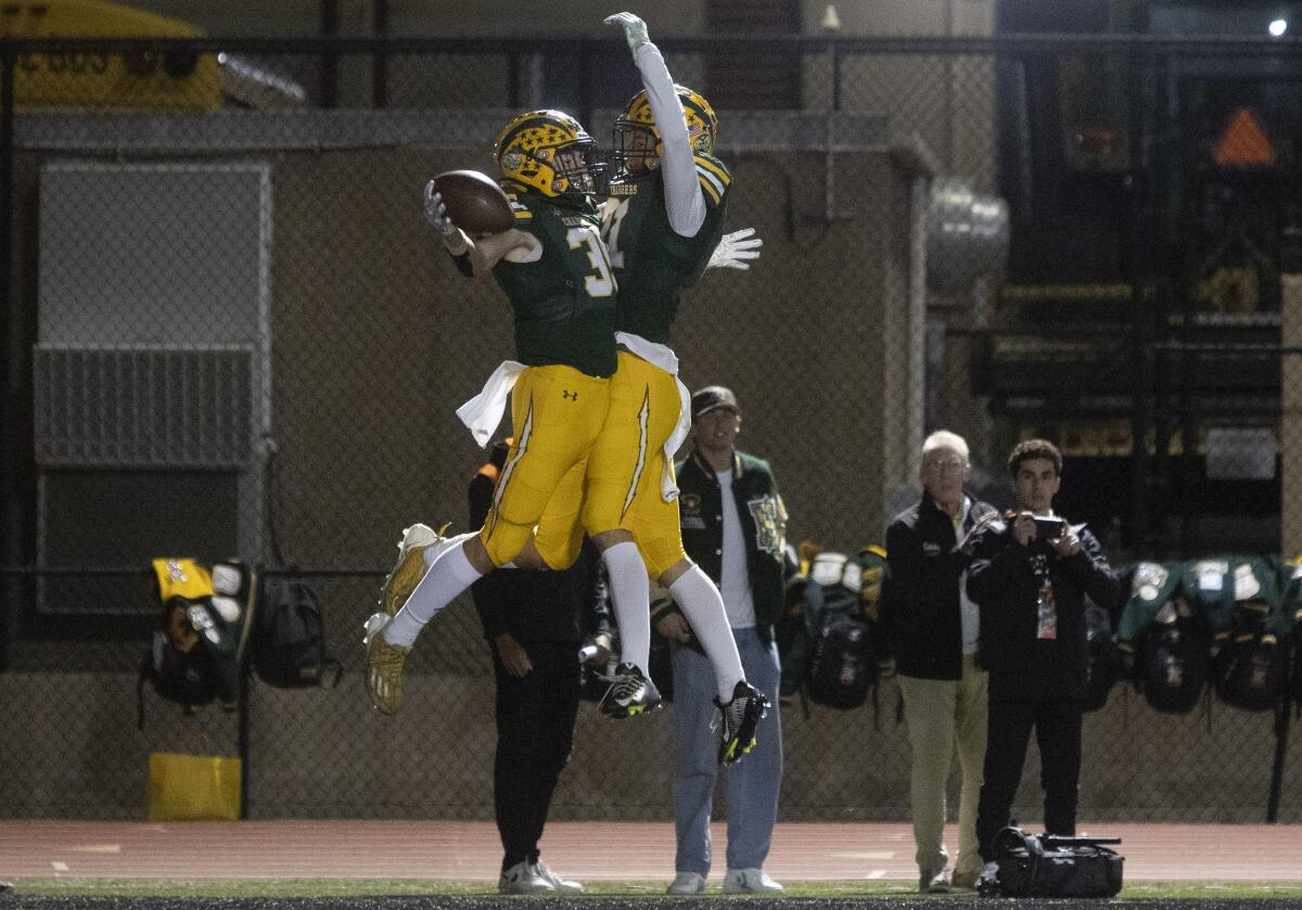 Edison players celebrate after scoring a touchdown against Orange Lutheran during Friday night's game.