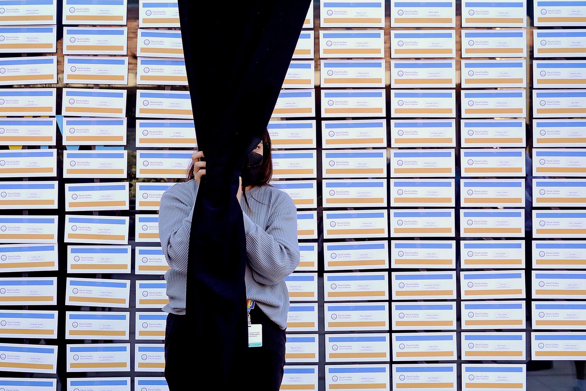 Envelopes are displayed behind a curtain.